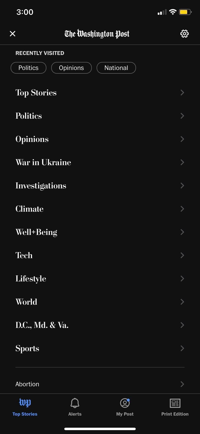​​Screenshot of the Washington Post mobile app shows the Top Stories tab contents. The settings menu gear icon is visible in the top right corner of the screen.